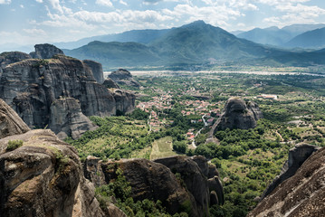 Fototapeta na wymiar Meteors or Meteora with Orthodox Monasteries, panoramic view from the plateau to the valley of Thessaly