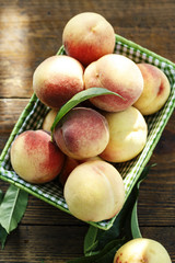 Fototapeta na wymiar ripe peaches on a wooden background