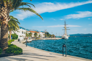 panoramic view of resort city at seaside with big white ship in port