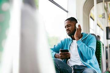 Man Riding In Bus Listening Music In Headphones