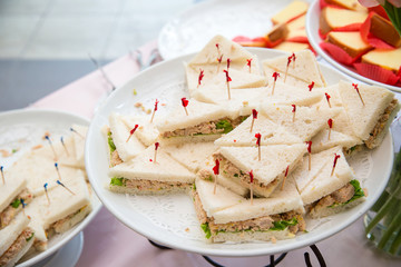 Freshly made club sandwiches. Club sandwich with sausage on a white plate. Club sandwich with cheese.