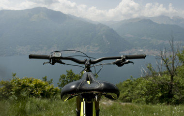 Naklejka na ściany i meble detail of handlebar and display of electric bicycle, e-bike, ebike, mountains, valley, lake of Como, summer, sport, adventure, freedom, sun, alps, Lombardy, Italy