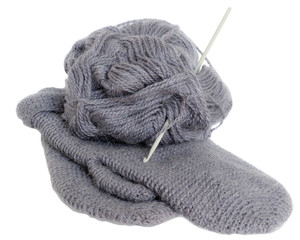 Hand knitted mittens and a skein of yarn isolated.