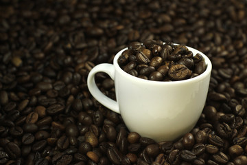 Composition of a cup of coffee with many coffee beans around. Concept: drink, breakfast