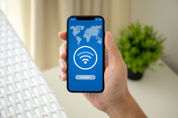 man hand holding phone with app search for free wi-fi