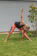 Attractive senior woman in a deep bow outdoors