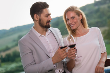 People sampling and tasting wines in vineyard