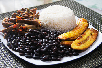 Homemade Venezuelan food. Traditional Venezuelan dish. Pabellon Criollo. White Rice, Black beans,Fried plantains, and Shredded beef