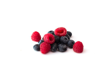 Blueberries and raspberries on white background.