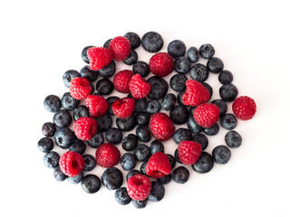 Blueberries and raspberries on white background.