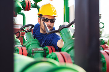 Engineer, working with pipeline controls inside oil and gas refinery