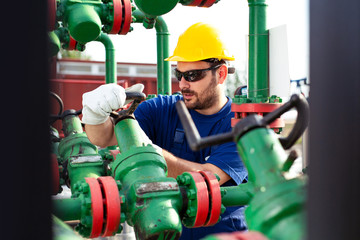 Engineer, working with pipeline controls inside oil and gas refinery
