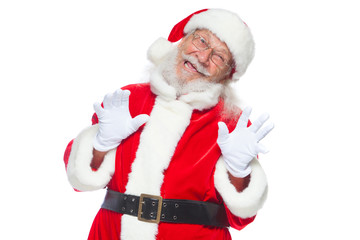 Christmas. Good Santa Claus in white gloves shows faces, grimaces, shows his tongue. Not standard behavior. Isolated on white background.