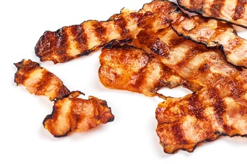 Grilled bacon on white. Crispy Cooked Bacon On Table. Unhealthy food. Risk of obesity. Homemade barbecue.