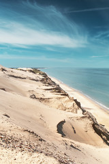 View of the danish sand dunes cliff in beautiful summer light conditions with the ocean overview. Rubjerg Knude Lighthouse, Lønstrup in North Jutland in Denmark, Skagerrak, North Sea