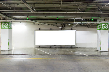 parking garage underground  interior with blank billboard.Empty space car park interior at afternoon.Indoor parking lot.interior of parking garage with car and vacant parking lot in building.