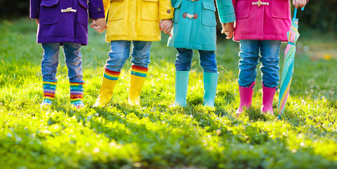 Kids in rain boots. Foot wear for children.