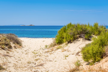 Sand dunes and sea in summer day on Naxos island, Greece