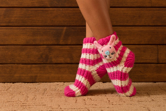 Funny pink socks on the legs of a little girl