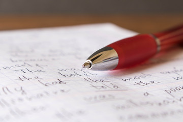 Pen and notebook in English at the school Desk. The concept of education