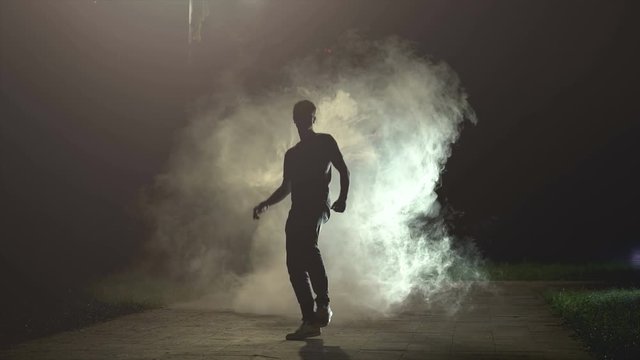 The fellow running in a cloud of smoke on the background of a dark, slow motion