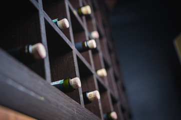 Wine bottles on shelf. Wine cellar. Close up wine bottles.