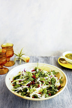 Fennel Herb Salad with Italian Style Salsa Verde. Photographed on a b;ack/grey background.
