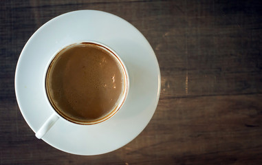 Coffee cup on wood table at work office,selective focus.