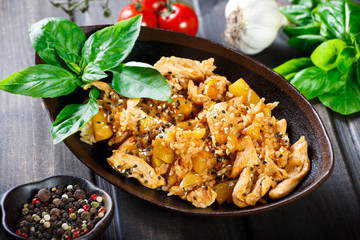 Rice with chicken meat, pineapple and sesame seeds on wooden table.Indian cuisine. Top view