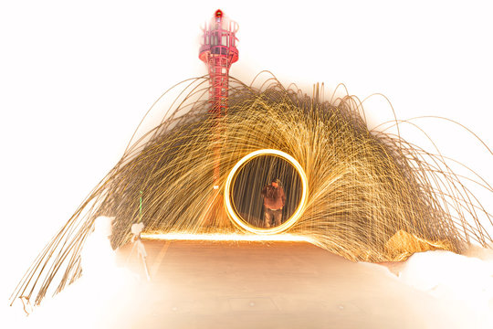 Burning steel wool wheel, fireworks effect at the lighthouse on white background