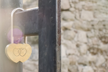 golden lock with engraving of two hearts