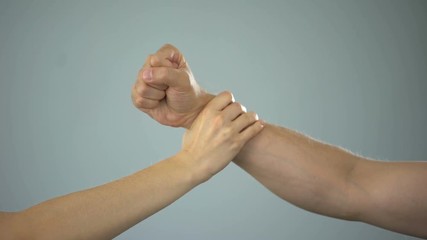 Female hand stopping man going to hit his relatives, stop assault in family