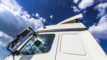 Clouds reflected in the Windows of the truck