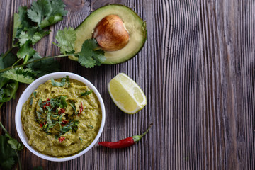Appetizing guacamole sauce from avocado pulp with the addition of cilantro, lime juice and other vegetables and seasonings is ready for use