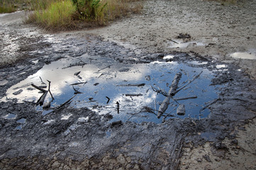 Spills of crude oil on the soil surface - environment pollution.
