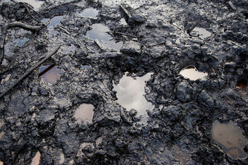 Spills of crude oil on the soil surface - environment pollution.