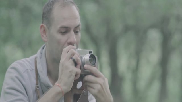 Photographer takes pictures with camera.