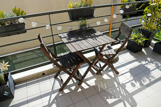 balcony with wooden furniture and decorations