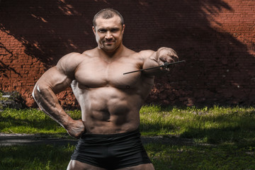 Fototapeta premium outdoor sport Brutal strong muscular men with sword