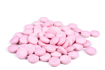 Obraz na płótnie Canvas Pink tablet pills on white.