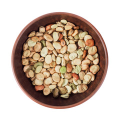 Useful, delicious natural food of village production. Beans of different colors, colorful, in a wooden plate on a white isolated background. 