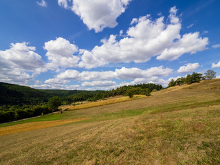 Autumnal countryside view with clouds and blue sky