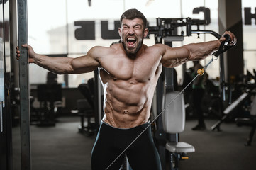 Fototapeta na wymiar Brutal strong bodybuilder athletic men pumping up muscles with dumbbells