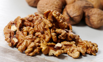 pile of walnuts on a white wooden table
