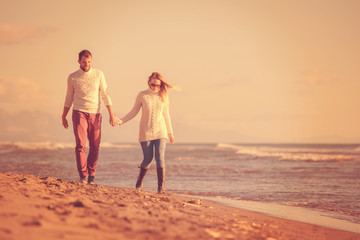 Fototapeta premium Loving young couple on a beach at autumn sunny day