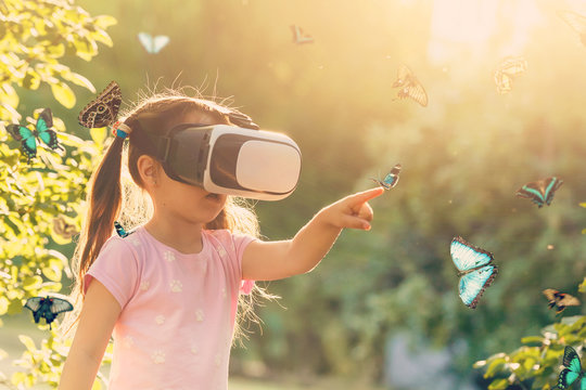 Excited siblings using virtual reality headset and looking at butterflies - Powered by Adobe