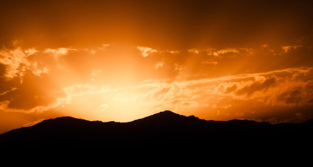 Golden Sunset with Mountains and Clouds