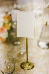 Naklejka na ściany i meble Blank poster on a wedding table.