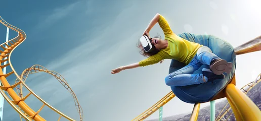 Tuinposter Young woman used Virtual reality helmet VR. She see Roller-coaster park © Anna Stakhiv
