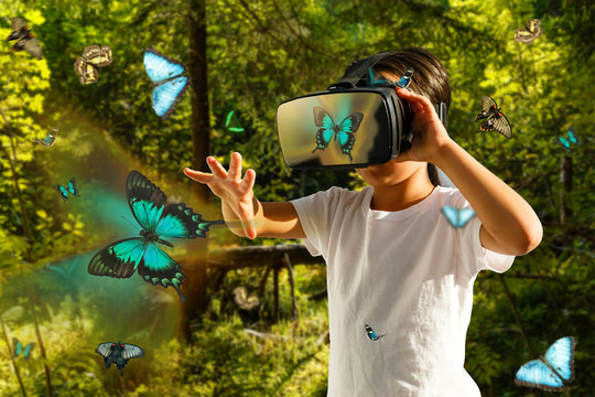 Excited siblings using virtual reality headset and looking at butterflies